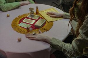 A spiritual tarot reading session with cards and crystals on a decorative table.